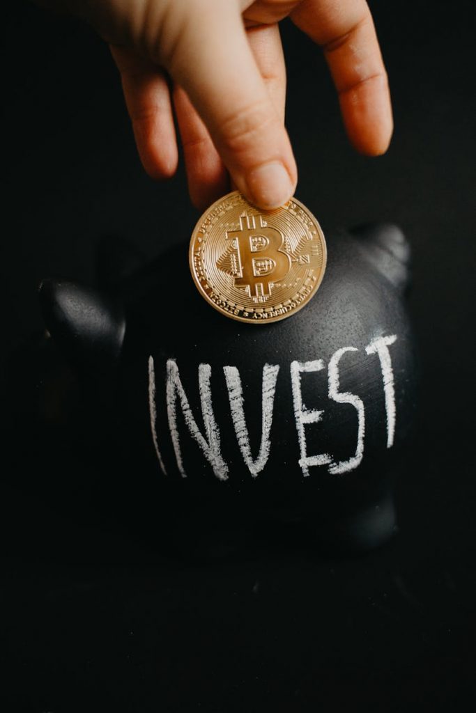 a person holding a coin Introduction to investments to young adults